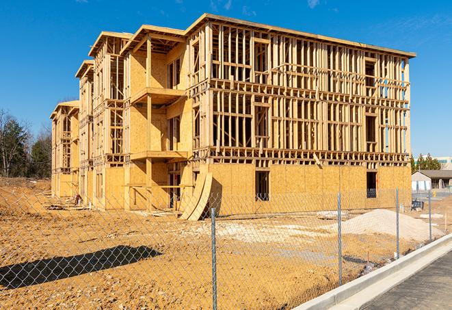 a temporary chain link fence surrounding a construction site, requiring strict safety precautions in Rockdale, TX